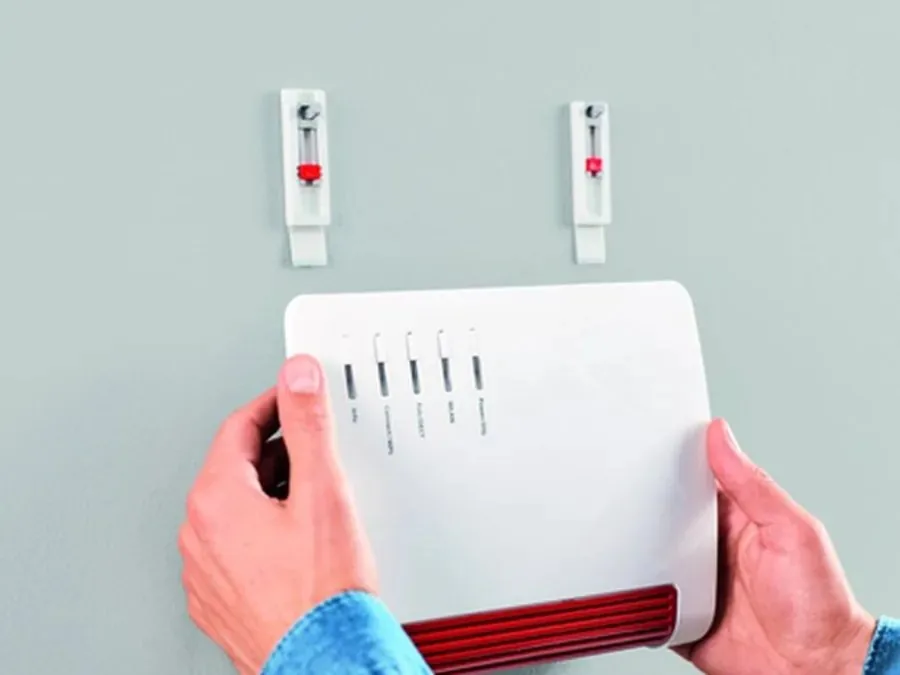 Router wird an zwei Halter an der Wand gehängt
